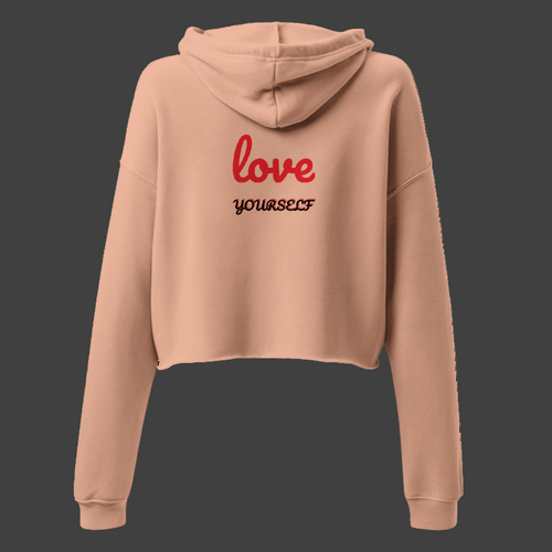 Beige hoodie with 'love yourself' text on the back against a white background